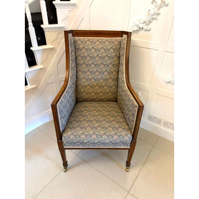 A very elegant antique mahogany bergère style wing armchair of generous proportions combining comfort with refined...