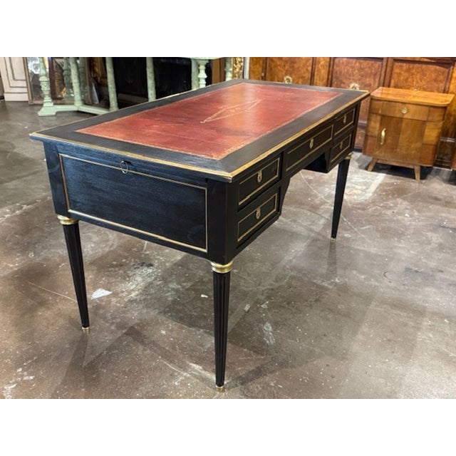 This product is a 19th Century French Louis XVI black lacquered desk with a leather top, featuring a black lacquered...
