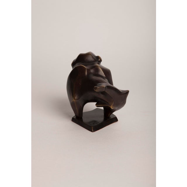 "Bulldog" A contemporary animal bronze of a bulldog at rest, head lifted and turned, body pared down to a few bold,...