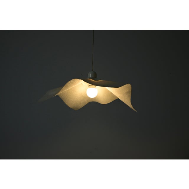 Paper and plastic pendant light by Mario Bellini with donut-shaped counterweight, model: Area 50. Wear due to time and age...