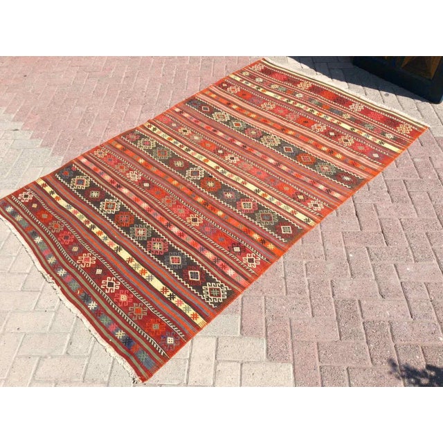 This beautiful, vintage, handwoven kilim is approximately 60 years old. It is handmade of very fine quality wool and...