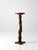 Rustic Adirondack plant stand featuring a natural twig pedestal wrapped with winding vine details and topped with a round...