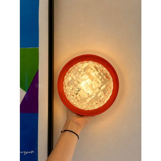 Pair of clear cut glass wall sconces. Removable orange metal ring. In excellent condition. 1960s/70s. New electrical...