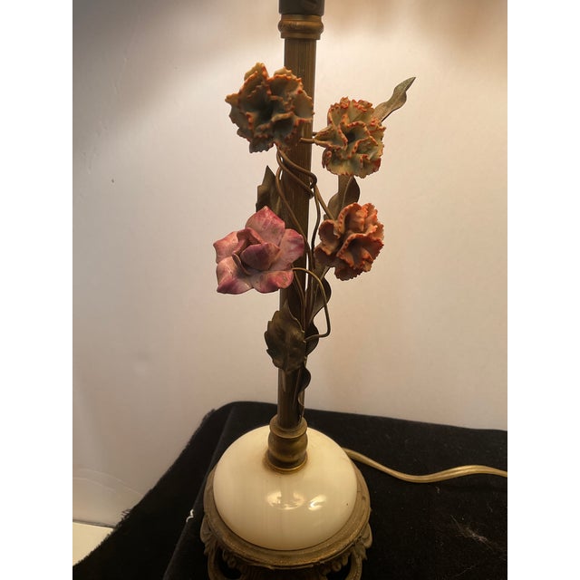 Italian metal Table lamps with decorative floral motifs and ornate marble bases with gold fringed shades. These became...