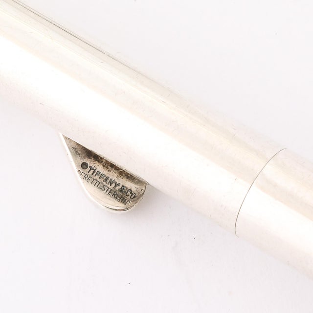 This Modernist Sterling Silver Ballpoint Pen with a sculptural clip, signed by the prestigious Tiffany & Co., is a...