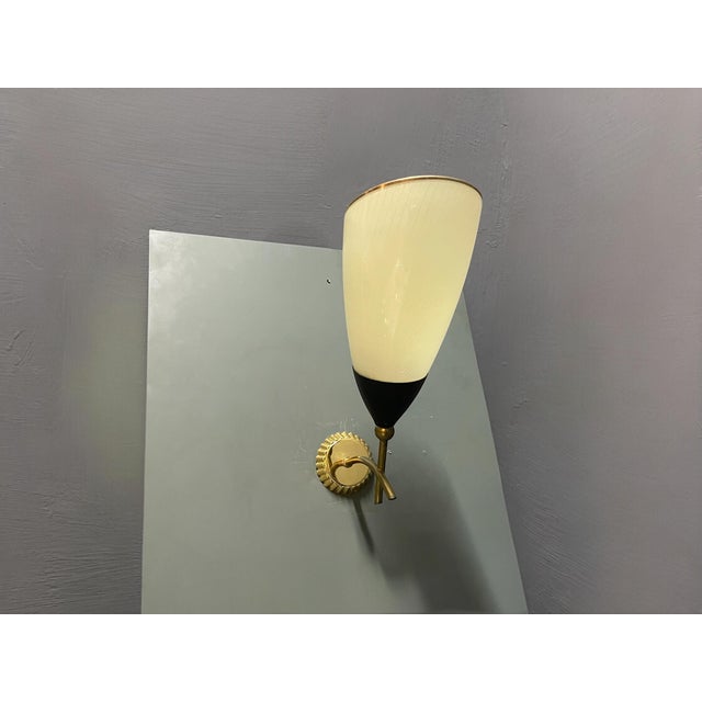 A striking pair of italian wall sconces attributed to the stilnovo style, dating from the 1960s. These elegant lights...