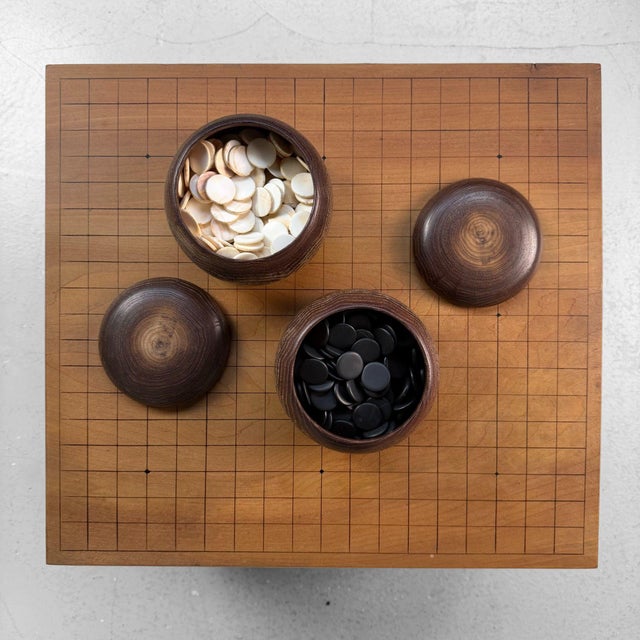 Beautiful vintage Japanese Go set, entirely handcrafted from solid keyaki (zelkova) wood. The thick board rests on four...