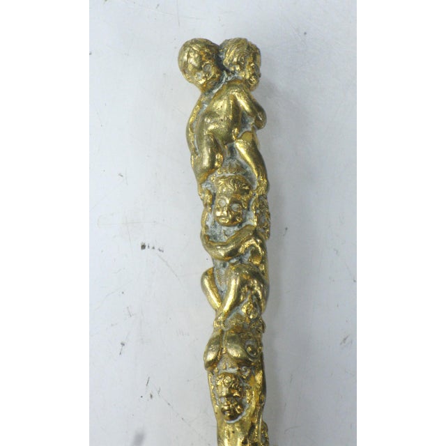 This antique gilt bronze butter knife is a unique and charming piece that adds a touch of Victorian elegance to any...