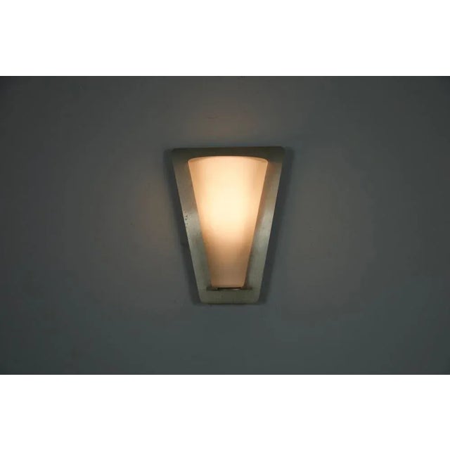 This striking wall lamp was crafted by glashütte limburg in germany during the 1960s. Its design features a tapered...