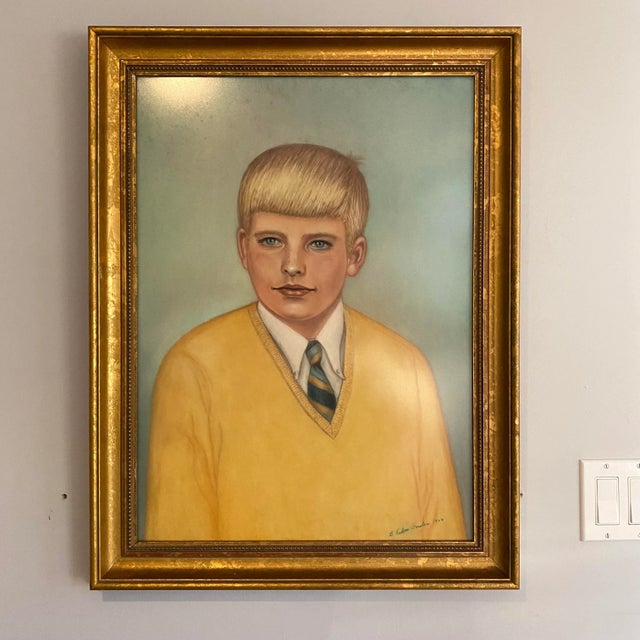 A campy 1966 framed and signed portrait of a young boy in a yellow sweater. Freckles and a tie, what more could you ask...