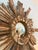 A beautiful carved sunburst mirror made of stained wood. Rare double wood rays. The mirror plate measures 5 inches in...