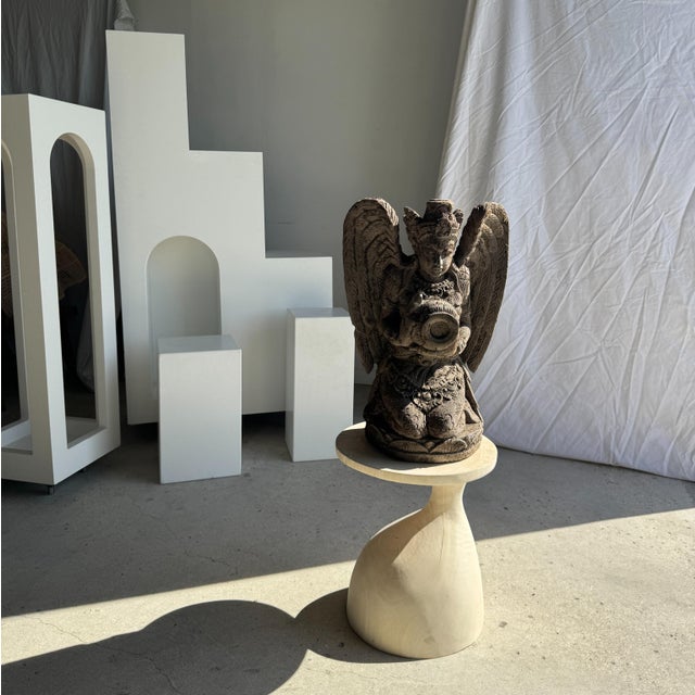 Traditional Indonesian sculpture of a winged deity in volcanic limestone. Height: 60cm; Base dimensions: 27cm x 29cm;...