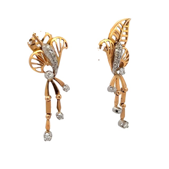 Elegant mid-century diamond drop earrings crafted in 14 karat yellow gold with white gold diamond accents, designed in a...