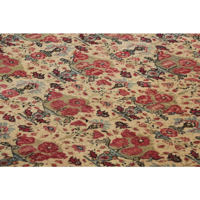 Made with hand-knotted wool circa 1900, this 10x13 antique Pesian rug is a rare new turn-of-the-century curation from Rug...