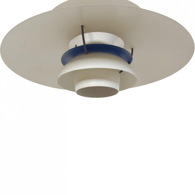 Poul henningsen ph5 pendant lamp with white metal shades. The lamp is from the 1990s and appears with marks and scratches....