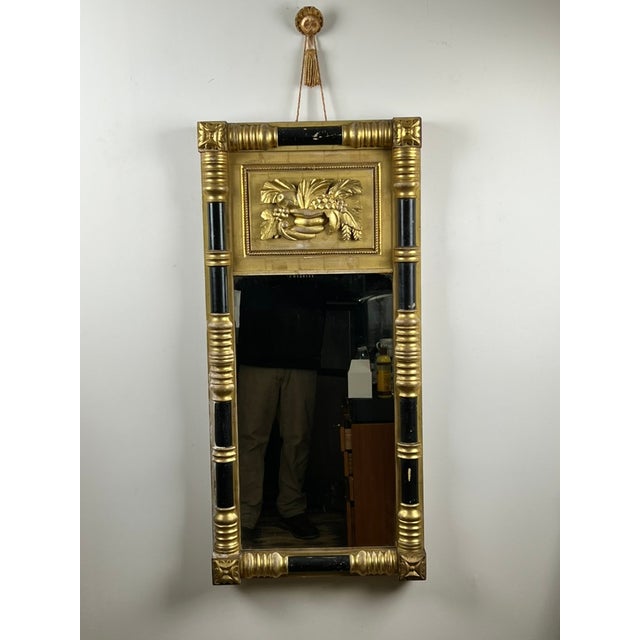 This handsome antique mirror dates to the Federal period and reflects the refined neoclassical design vocabulary popular...