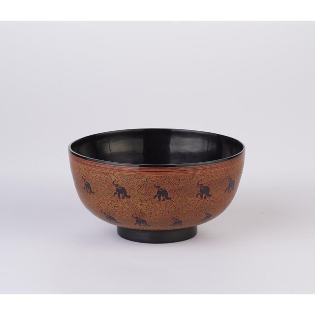 A classic Myanmar motif comes to life with this enchanting, footed bowl, where a proud ring of circling elephants steals...