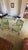 Classic pair of French fauteuils with carved wood frames, button tufted backs and sage green velvet cushions. • Set of 2...