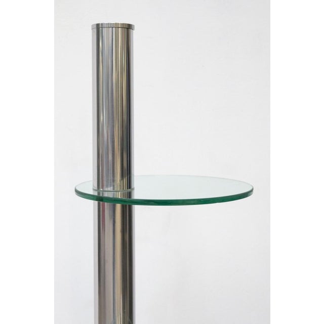 Detail of 70s furniture with circular shelves Base and tubular structure are made of steel, the three shelves are made of...