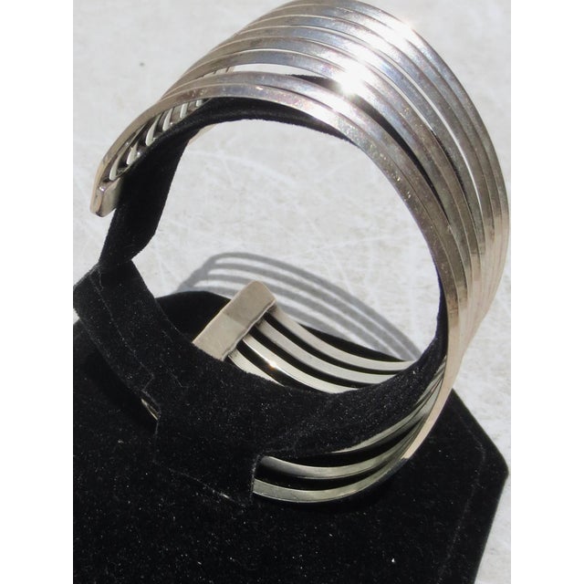 Modernist sterling cuff bracelet. Multi-band design in a wide cuff design. The measurement is 1.6" wide, and the weight is...