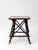 An antique Adirondack twig table featuring bark-on branch construction, crossed twig stretchers, and a softly faded floral...