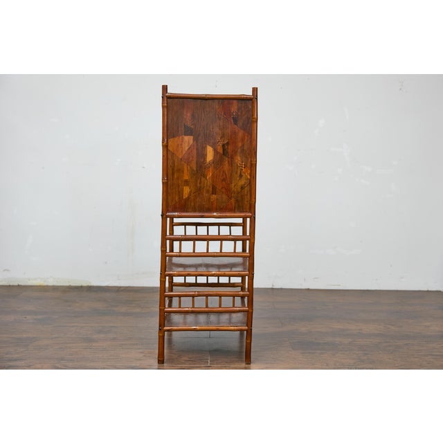 A 19th century English bamboo bedside cabinet from the 19th century with parquetry décor. This 19th-century English bamboo...
