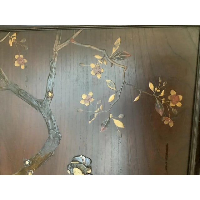 Carved and inlaid in high relief with gold details, these richly decorated plaques depict celebrated episodes from Japan's...