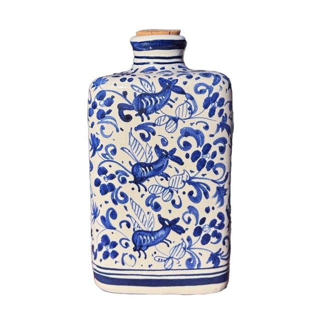 An uncommon Italian maiolica apothecary jar in a striking triangular form, hand-painted in saturated cobalt on a crisp...