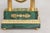 This is a striking Russian Empire-style portico mantel clock, richly veneered in vibrant green malachite and adorned with...