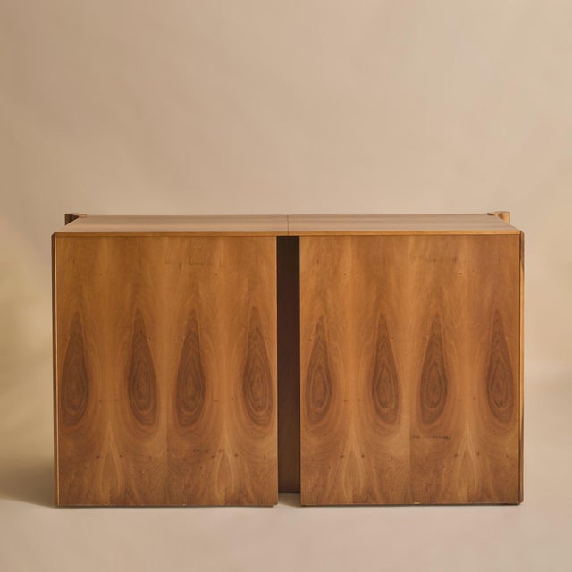 An Italian walnut 'Scuderia' sideboard attributed to Carlo Scarpa for Bernini, designed in the 1970s. Crafted in richly...