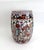 Striking mid-century Chinoiserie Famille Noire porcelain garden stool featuring a dramatic glossy black glaze, the barrel-...