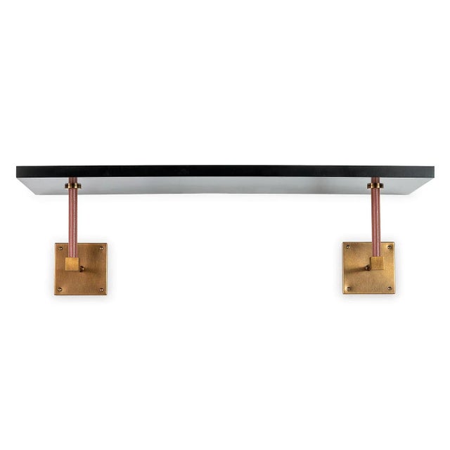 Billy is the black 36" wide single wall shelf which features faux brown leather and aged brass finished support pole...