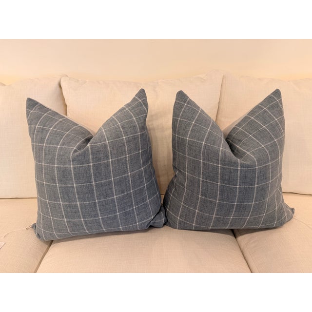 Contemporary accent pillow featuring a tailored windowpane plaid design in a soft dusty blue and ivory linen blend fabric....