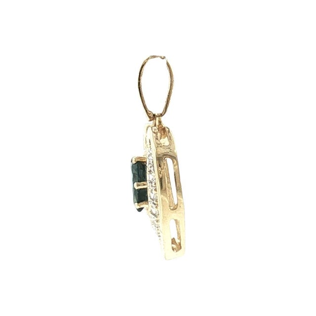 This late 20th-century pendant showcases a captivating blue sapphire, expertly cut in a pear shape, nestled at its heart....