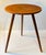 Circular side table in teak veneer resting on 3 solid tapered teak legs. It was manufactured in Denmark during the 1960s....
