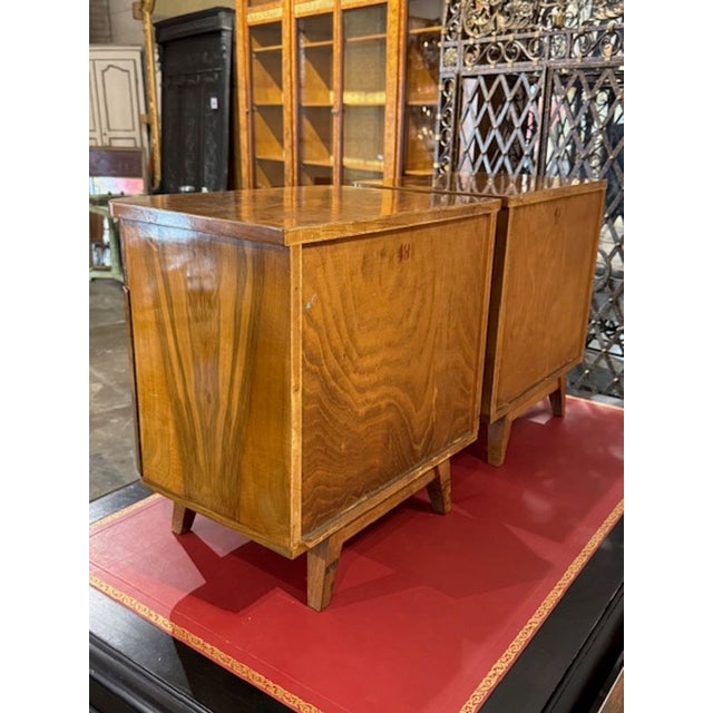 This product is a pair of elegant Italian Art Deco style side tables made from Olivewood. The tables feature brass...