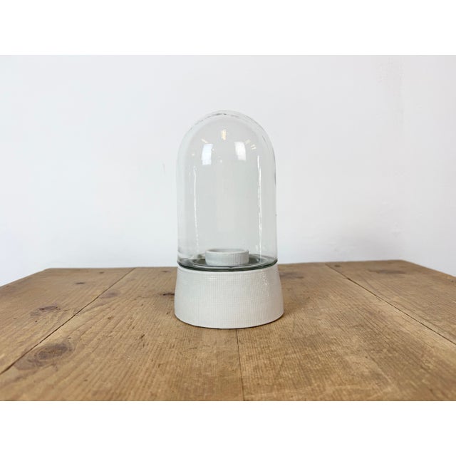 Vintage industrial ceiling or wall light made in former Czechoslivakia during the 1970s. It features a white porcelain...