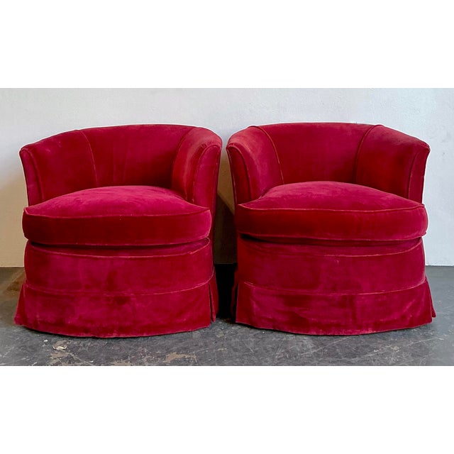 This striking pair of custom-crafted barrel swivel chairs is a masterclass in Hollywood Regency glamour and vibrant...