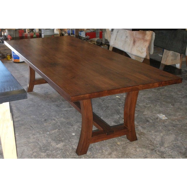 This custom trestle table is made from vintage walnut and designed by Luca Cavallo. 9-10 weeks