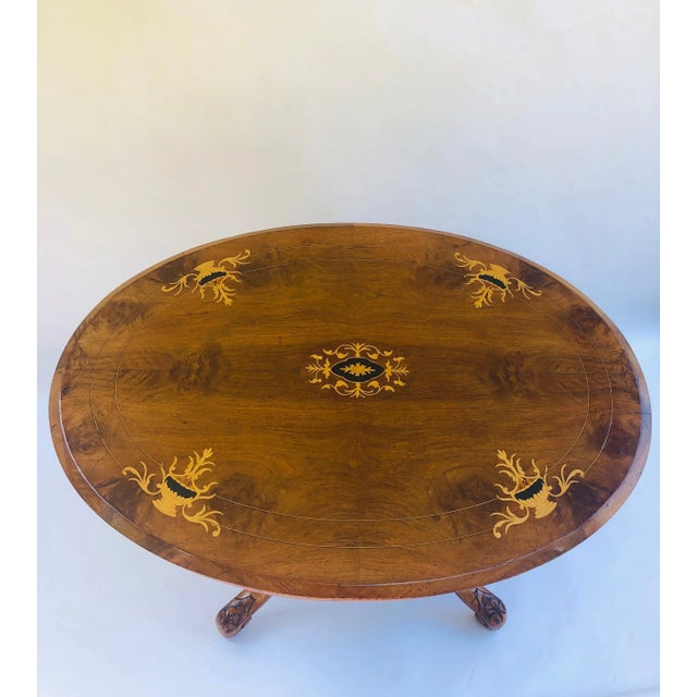 Antique Victorian walnut inlaid oval centre table having a charming walnut top with attractive boxwood inlay. The oval...