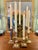 We have collected a set of 7 different solid brass candlestick holders ready to use. This set can fill up a mantle display...