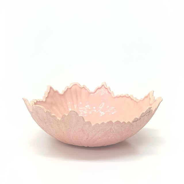 This is a beautiful blush pink ceramic bowl with floral detailing. The exterior is matte and slightly textured while the...