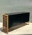 This vintage rattan and lacquered wood sideboard is a sophisticated example of Mid-Century Modern design, blending natural...