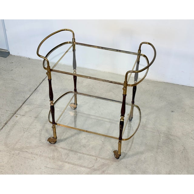 1960s bar trolley, brass and wood structure, glass shelves, height at the top 62 cm.