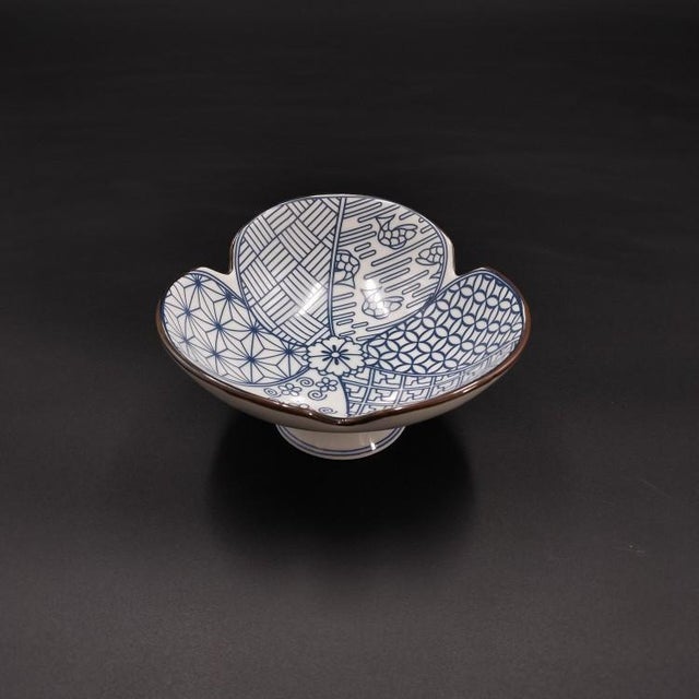 A pair of ceramic pedestal dishes with a petal rim; suitable for serving snacks or fruit, or for use as a tray to hold...
