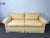 A custom, well-made two-seat sofa with a hardwood frame, classic rolled arms, loose down-filled cushions, and dressmaker...