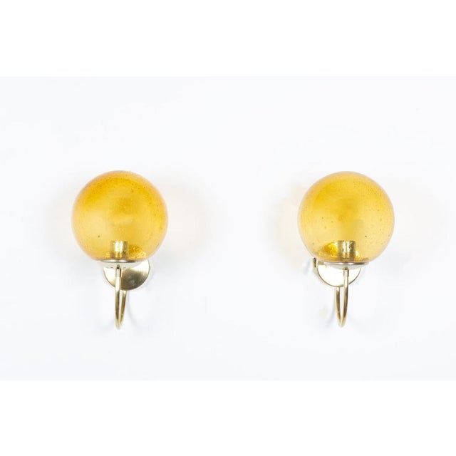 Set of 2 wall lights from the seventies edited by Parscot ( stamp inside the light, see picture) Brass arm and smoked...