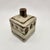 Square ceramic bud vase with cream glaze, hand-painted brown dot motif band, linear border detailing, and cylindrical neck