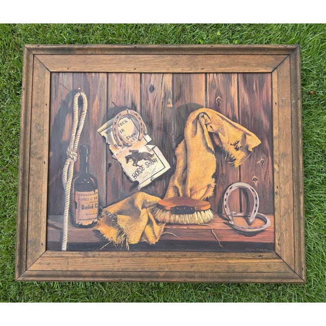 A finely executed vintage trompe-l’oeil oil painting depicting a collection of Western ranch objects including horseshoes,...