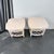 A delightful pair of vintage rattan and wood side tables featuring a soft white painted finish and decorative woven...